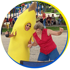 Banana Lady dancing with a parade-goer